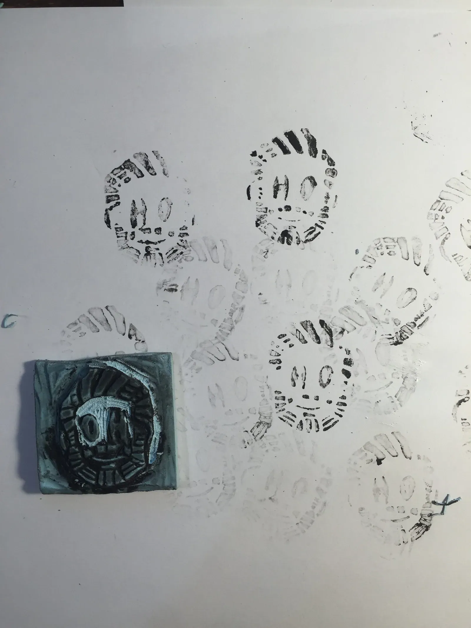stamp carving of happy Oscar logo